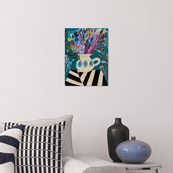 Flowers in vase on striped tablecloth