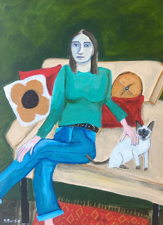 Woman and her Siamese cat on the coach