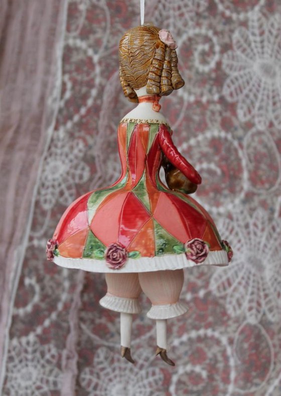Girl with a mandolin. Sculptured bell-doll