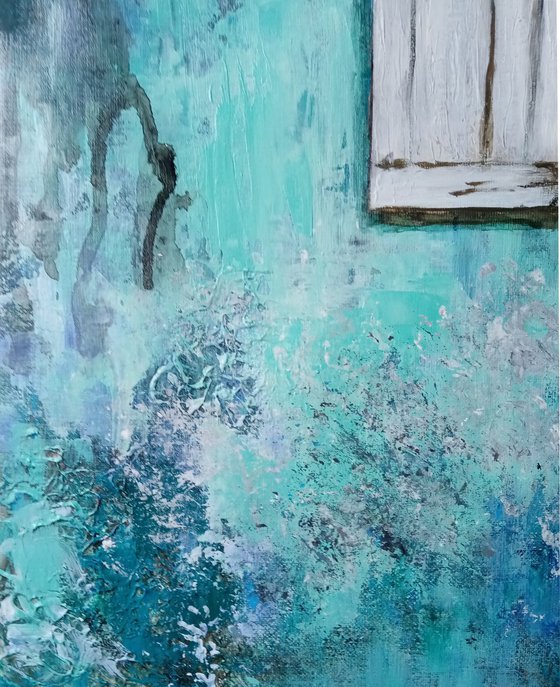A window in a turquoise wall