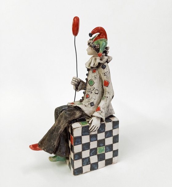 The Clown Sitting on a Chess Cube