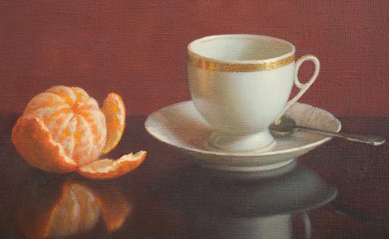 Cup of coffee and tangerine