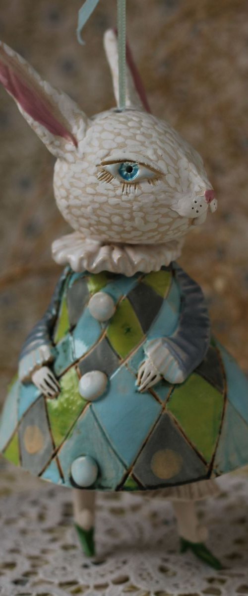 Little rabbit in harlequin dress. Hanging sculpture, bell doll by Elya Yalonetski by Elya Yalonetski