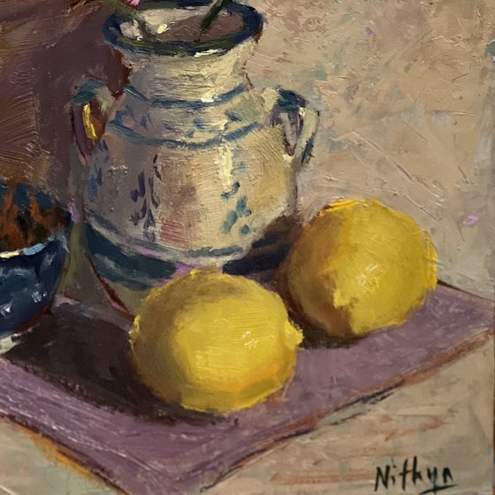 Lemons and flowers with a vase