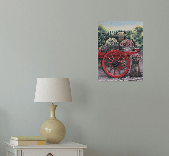 Old red cart with flowers