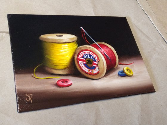 Vintage cotton reels with buttons still life