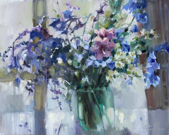 Blue wildflowers on  window
