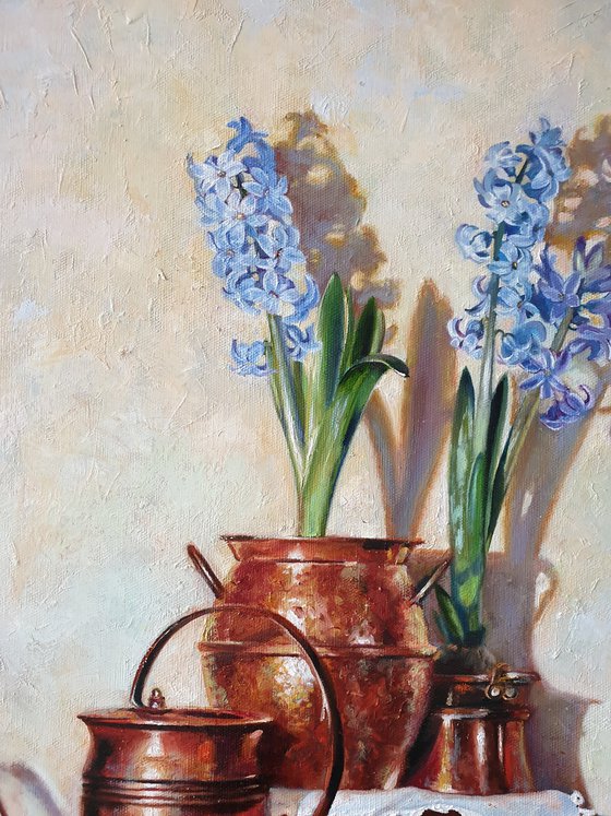 "Blue hyacinths in copper jugs."