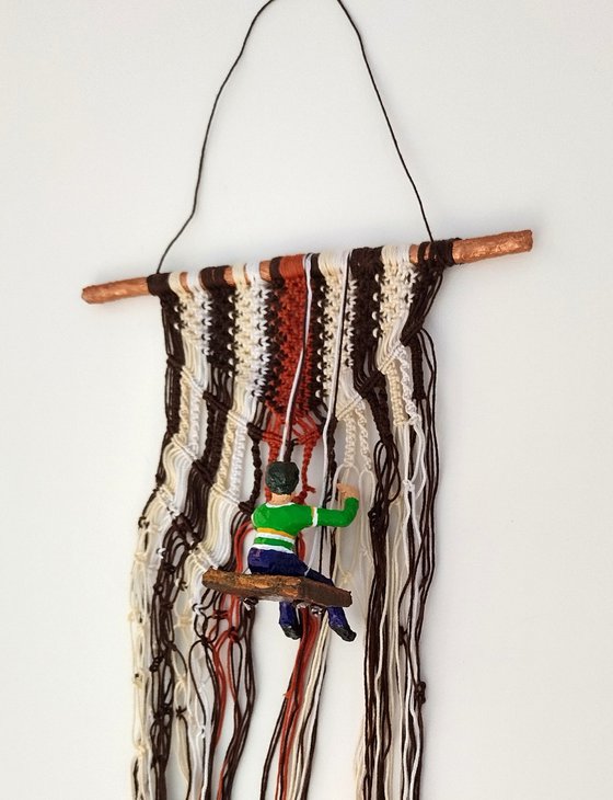 Boy on the macrame wall hanging