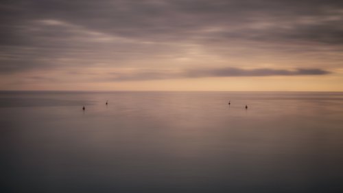 Four buoys at sunset by Karim Carella