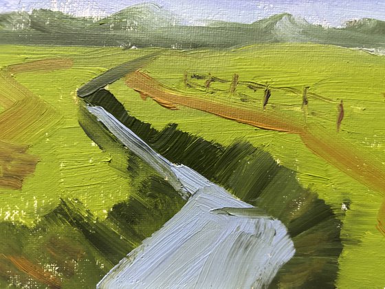 Clouds over the field and ditch