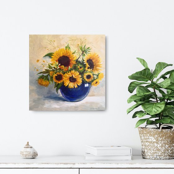 Sunflowers bouquet in a blue glass vase still life