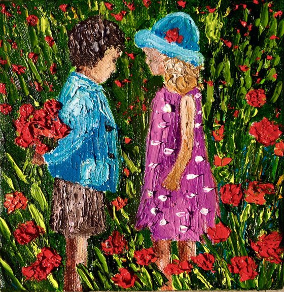 Boy and a girl on the flowers field