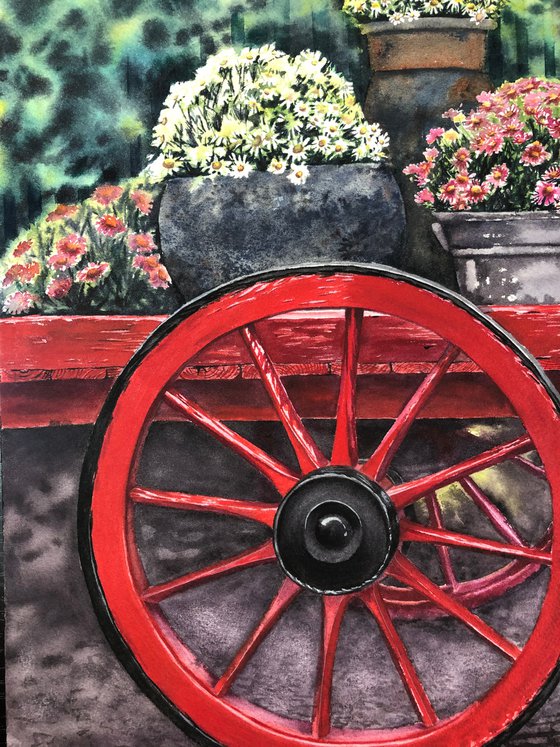 Old red cart with flowers