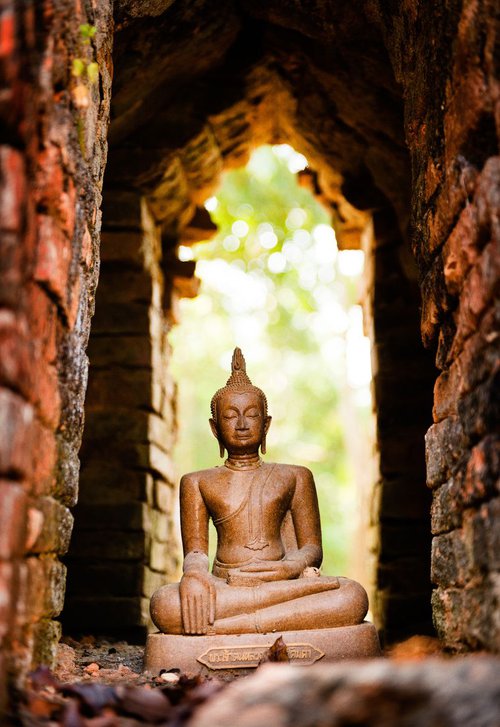Buddha in temple ruin by Tom Hanslien
