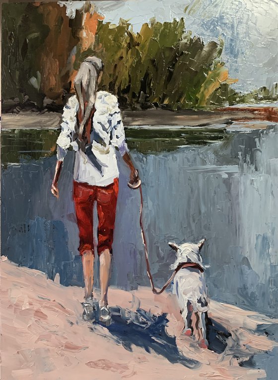 Woman walking with a dog.