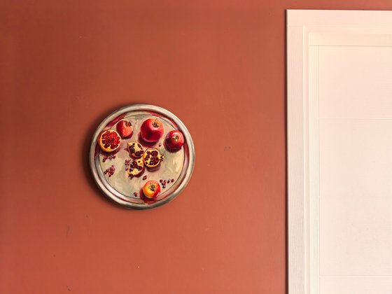 Pomegranates on metal try