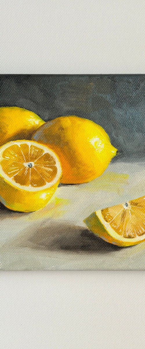 Lemon on grey fruit still life by Leyla Demir