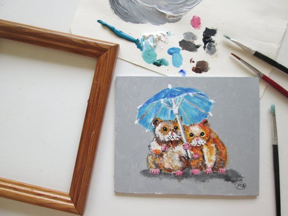 Lovely Hamsters together under a parasol