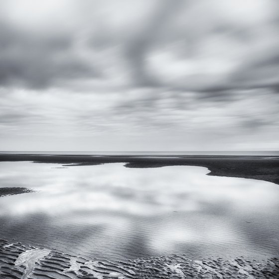 Low tide and reflected clouds