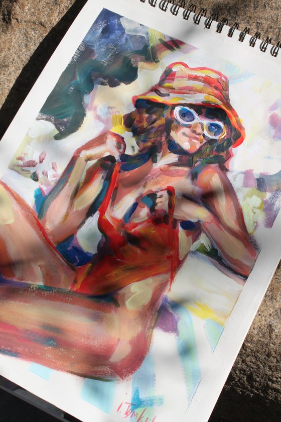 Girl in a red orange swimsuit and panama hat