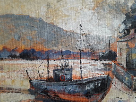 Old longboat in evening bay