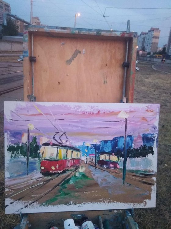 Streetcars in the evening city. Pleinair painting