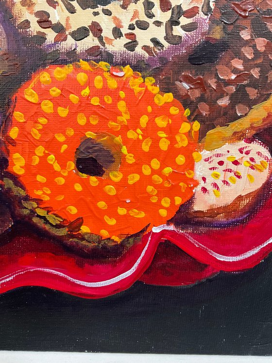 Colourful donuts in red dish