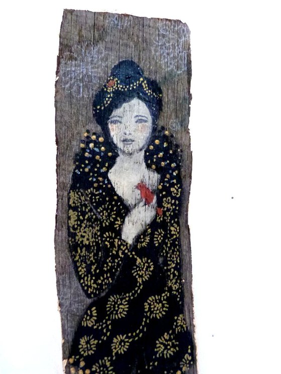 Painted wood, woman with a red bird.