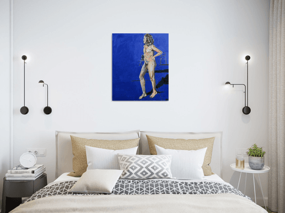 Young nude man in blue room