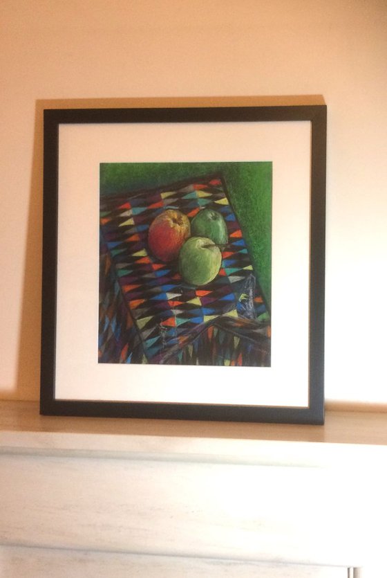 Still life three apples on a Harlequin background