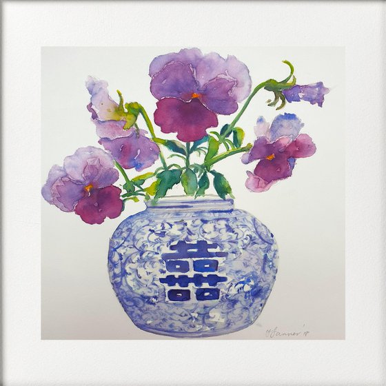 Purple pansies in a blue & white vase