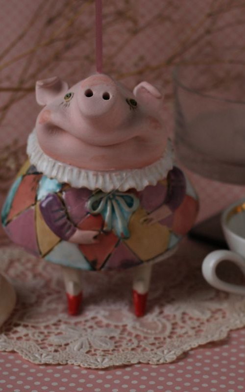Little piggy in harlequin dress. Hanging sculpture, bell doll by Elya Yalonetski by Elya Yalonetski