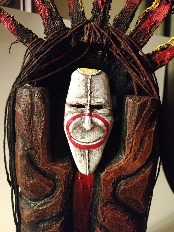 Mask of a smiling god. original sculpture