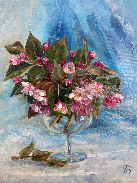 Spring mood. Bouquet in a glass on a blue background.