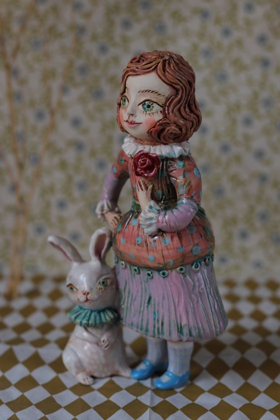 Vintage dressed girl with a rabbit