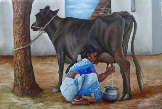 Woman milking cow