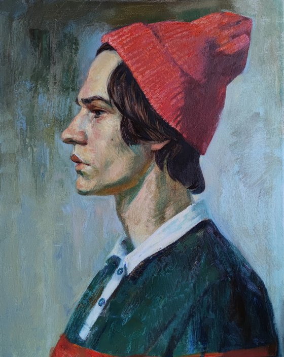 Portrait of a young man in a pink hat