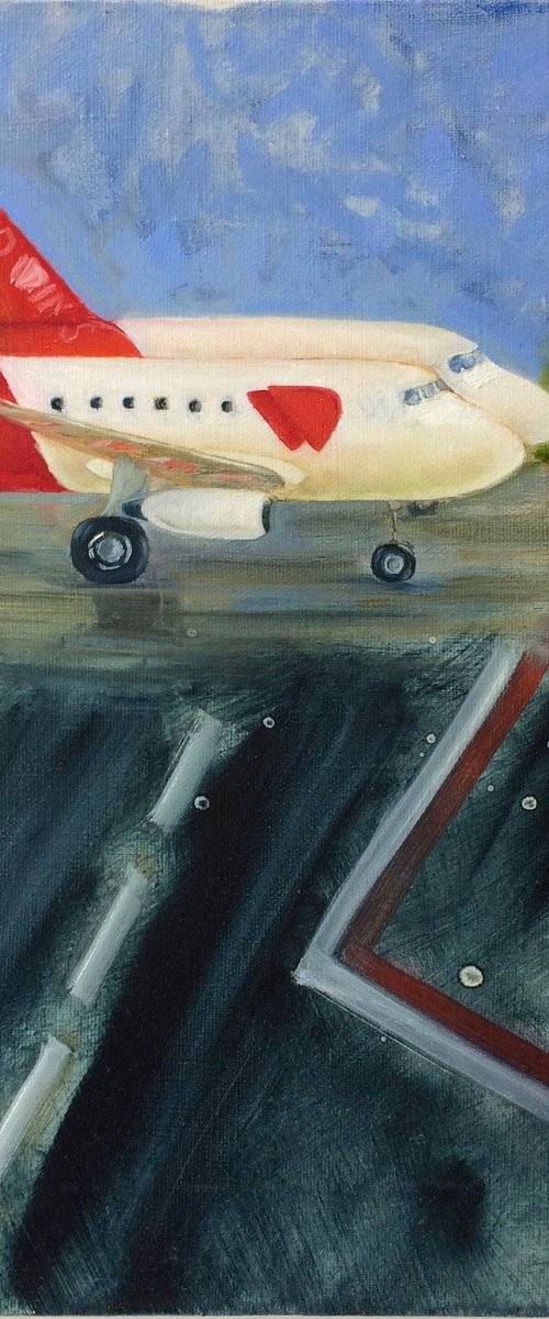 Two red and white airplanes on airfield by Olga Ivanova