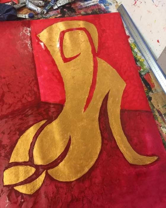 Golden nude seated in red studio