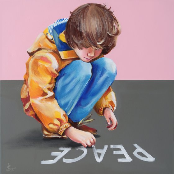 A boy drawing with chalk. Peace
