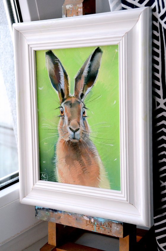 Portrait of a hare on a green background