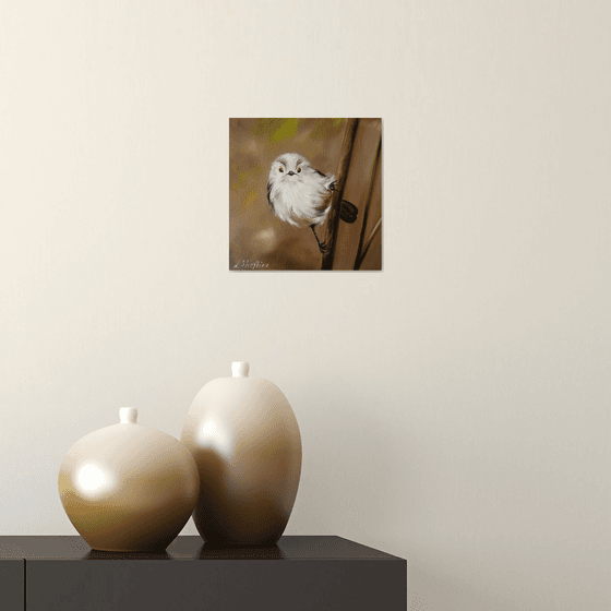 Fluffy White Bird on Branch