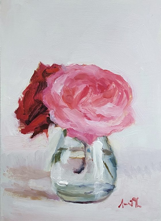 Pink and red Roses in a glass vase.