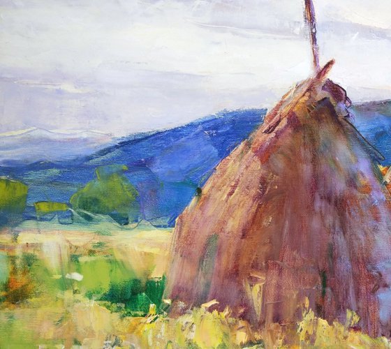 Autumn fields with haystacks