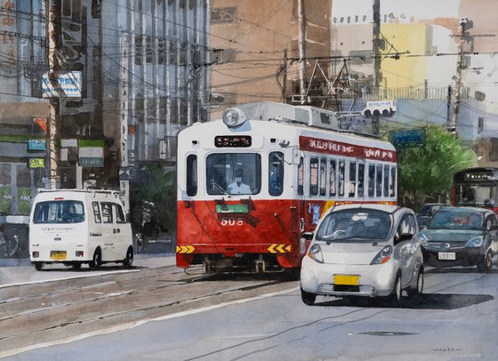 Red and White Tram in the City
