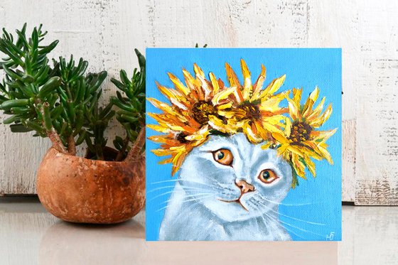 Cat and a wreath of sunflowers