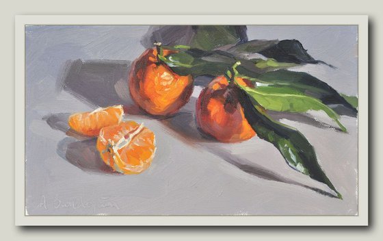 Clementines with leaves, grey background