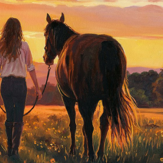 Woman walking with a horse in a sunset field