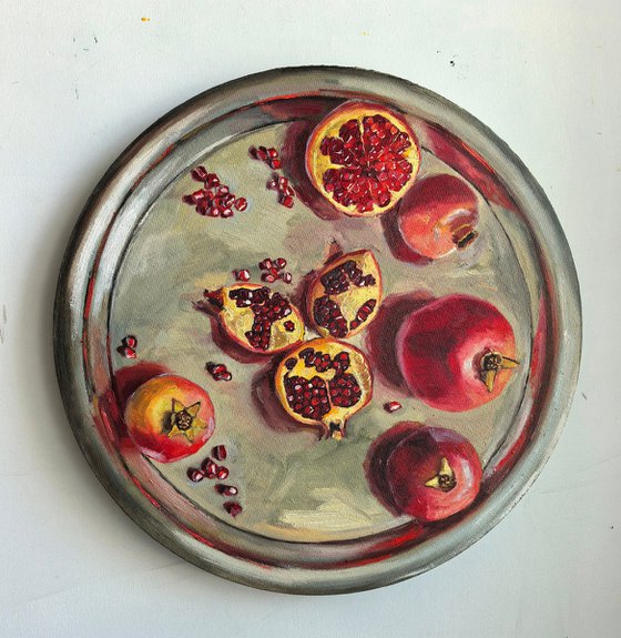 Pomegranates on metal try